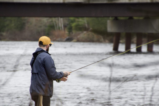 Man fishing in bright yellow hat close up